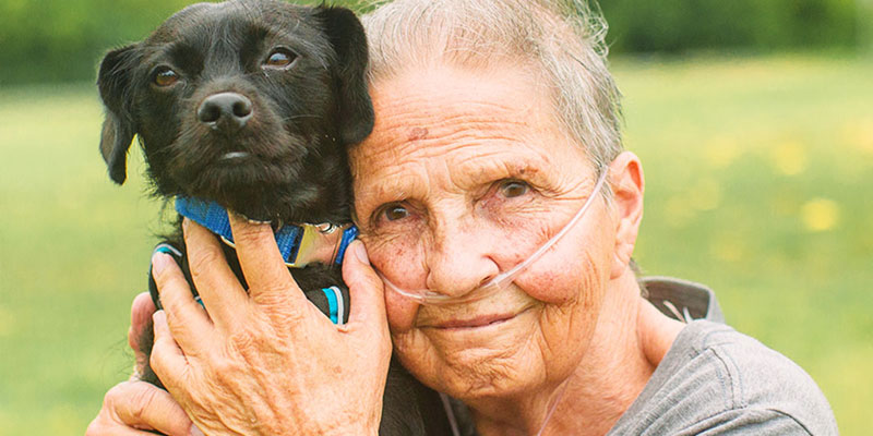 woman with small black dog