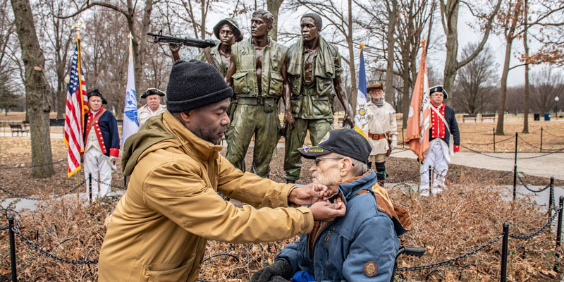 veteran receiving pin during small ceremony